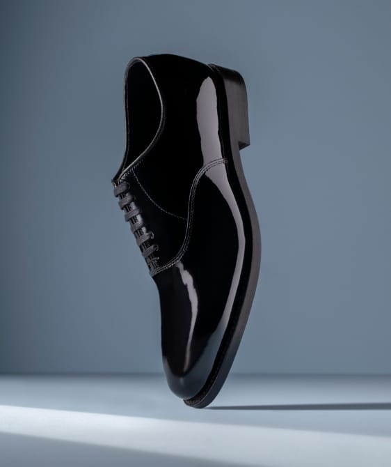 Men’s gray textured leather sneaker with tan rubber sole and brown leather lining