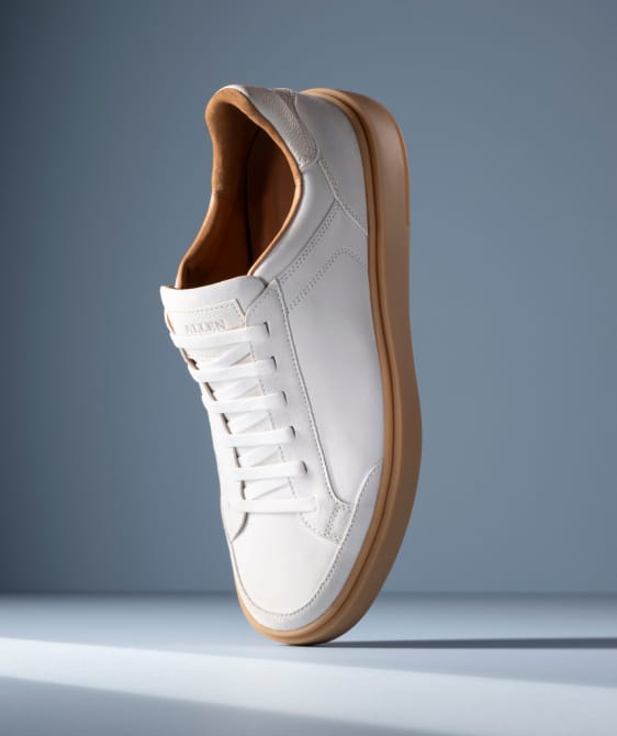 Men’s gray textured leather sneaker with tan rubber sole and brown leather lining